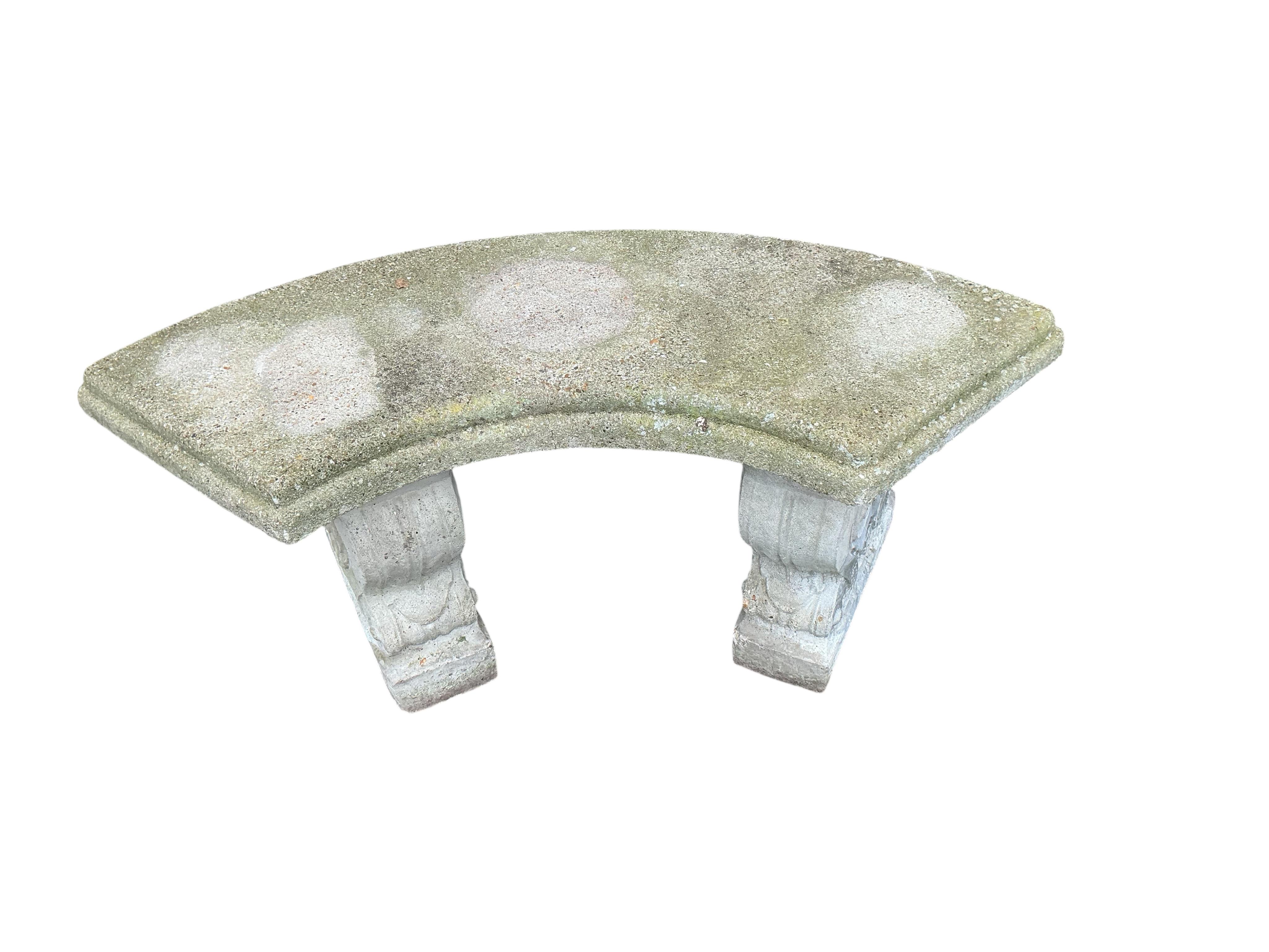 A reconstituted stone curved garden bench, width 106cm, height 44cm